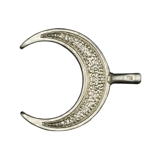 close-up of a silver crescent moon charm with clear pave stones on a black background