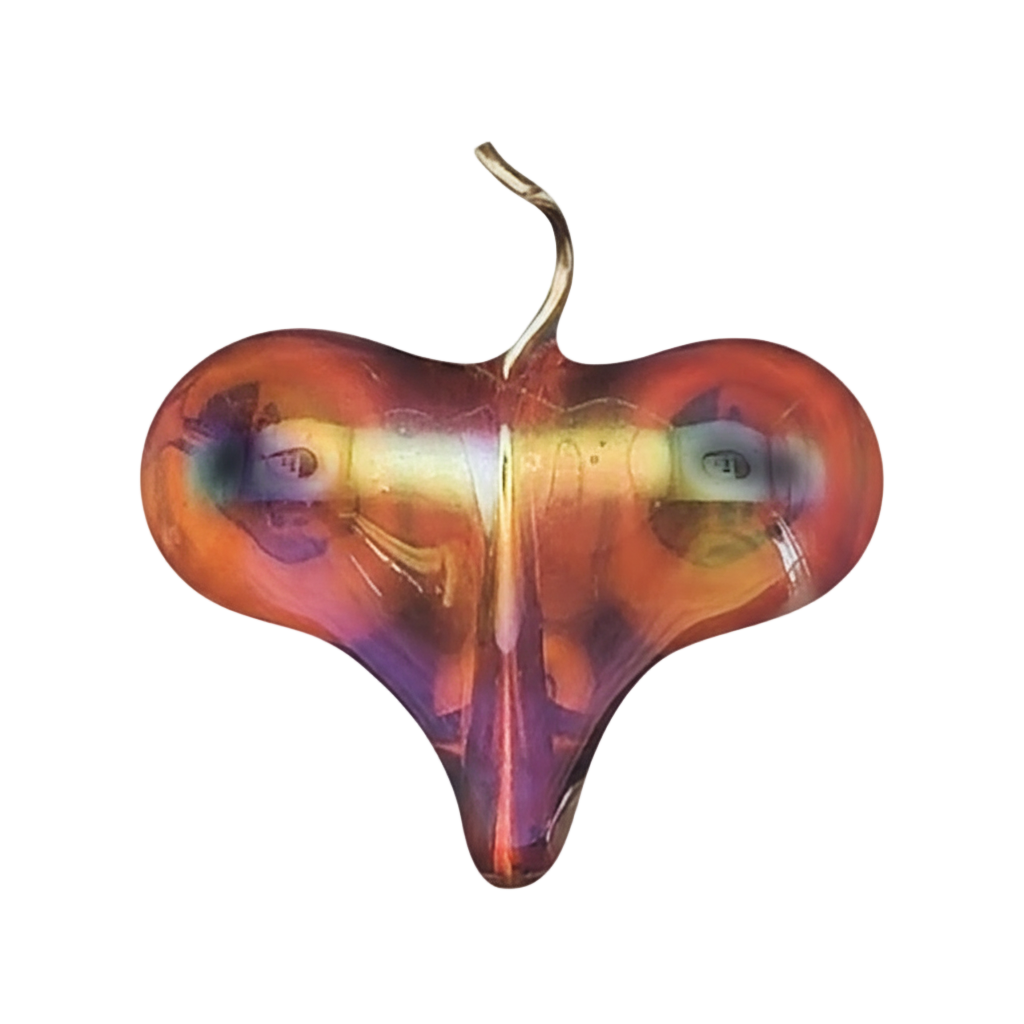 close-up of an iridescent glass heart charm on a black background