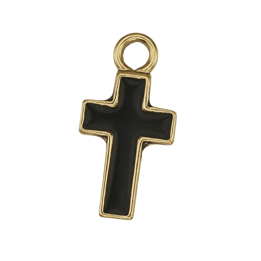close-up of a small black cross charm with a gold border on a black background