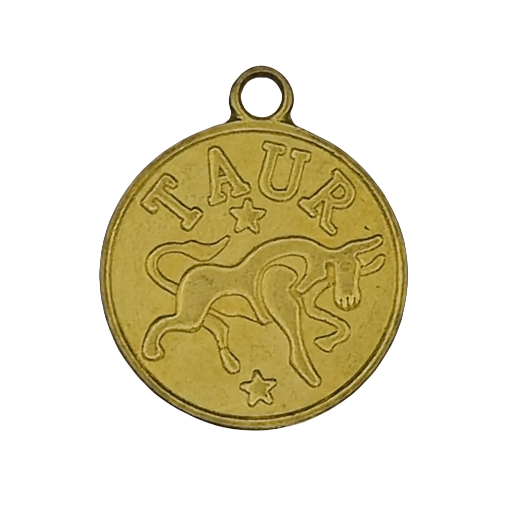 close-up of round gold Taurus zodiac charm with bull and stars