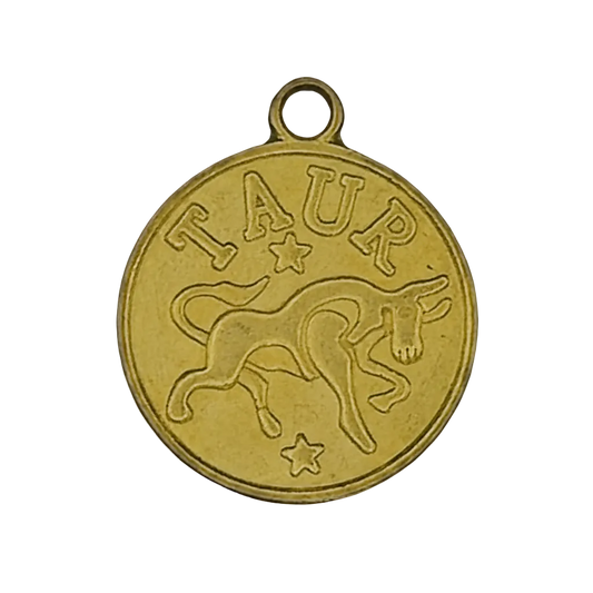 close-up of round gold Taurus zodiac charm with bull and stars