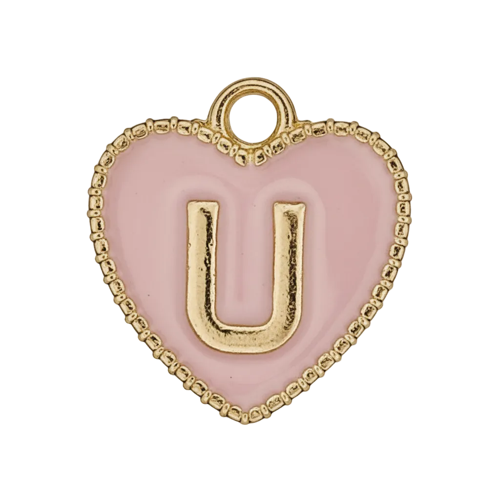 close-up of a pink heart charm with a gold letter U