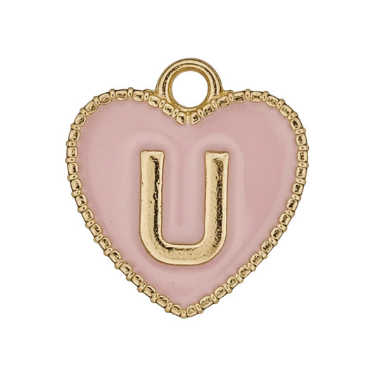 close-up of a pink heart charm with a gold letter U
