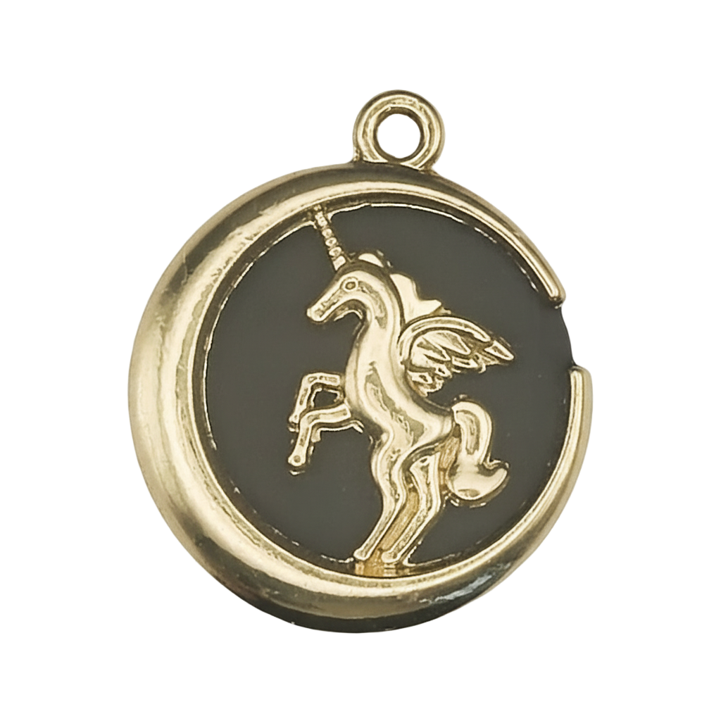 close-up of round gold-tone charm with raised winged unicorn on black background