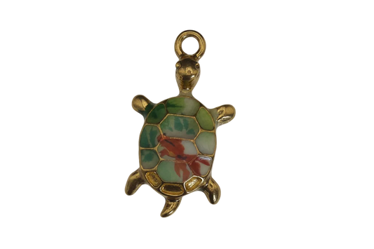 Close-up of a gold-tone turtle charm with a green and red shell on a black background.