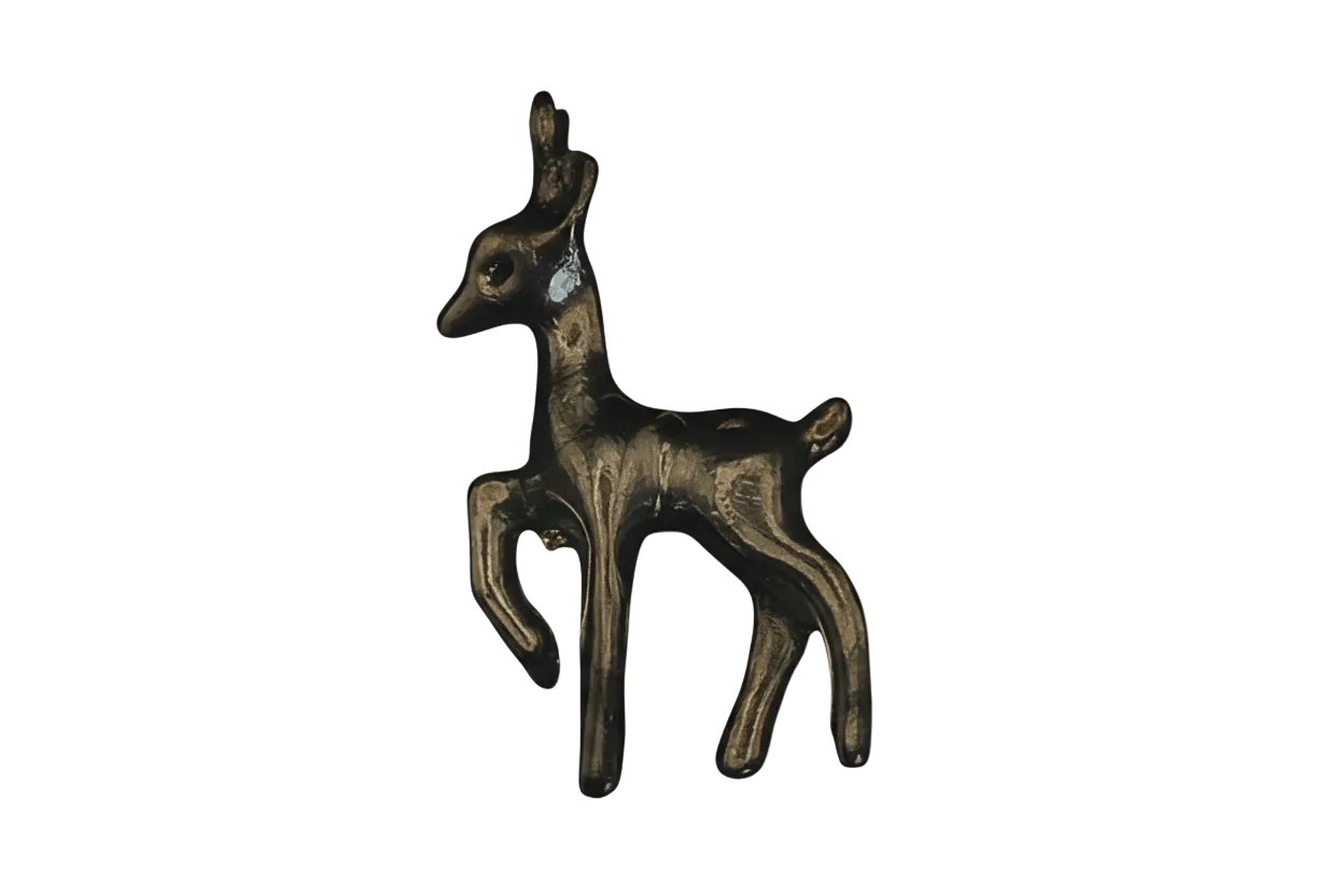 close-up of a small gold deer fawn charm on black background