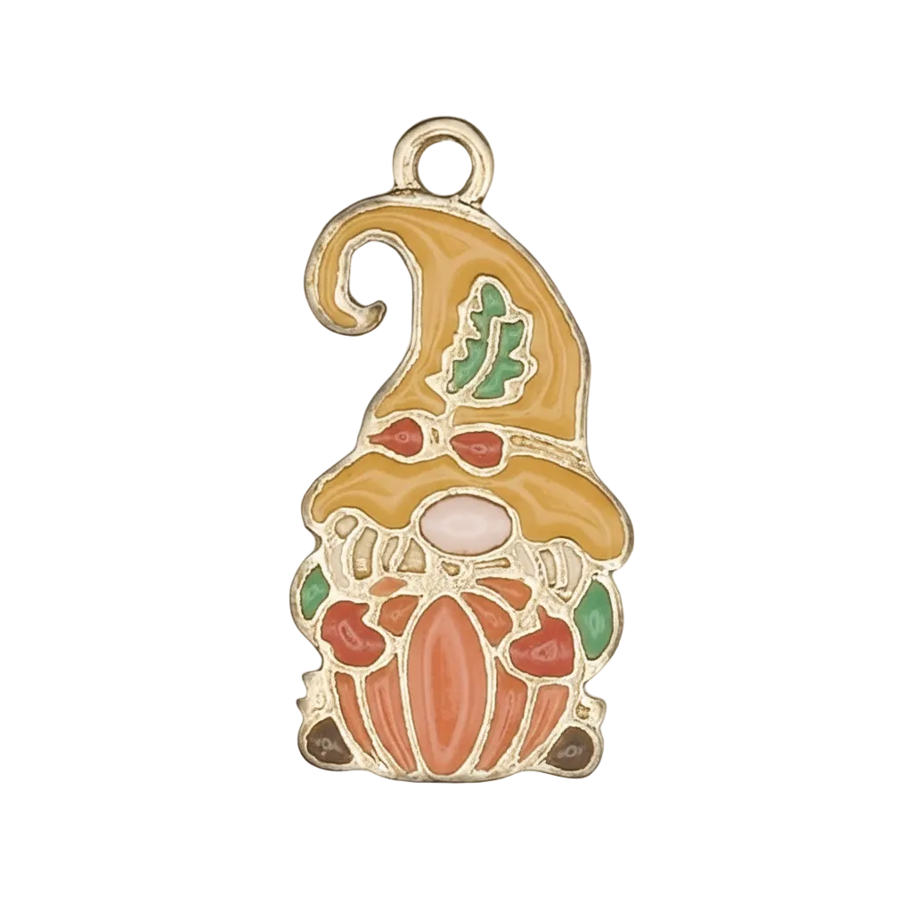 Close-up of gold-tone enamel gnome holding a pumpkin charm with yellow hat and green leaf on black background.