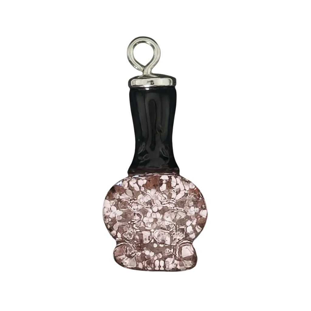 close-up of a nail polish bottle charm with a black cap and pink glitter bottle on a black background