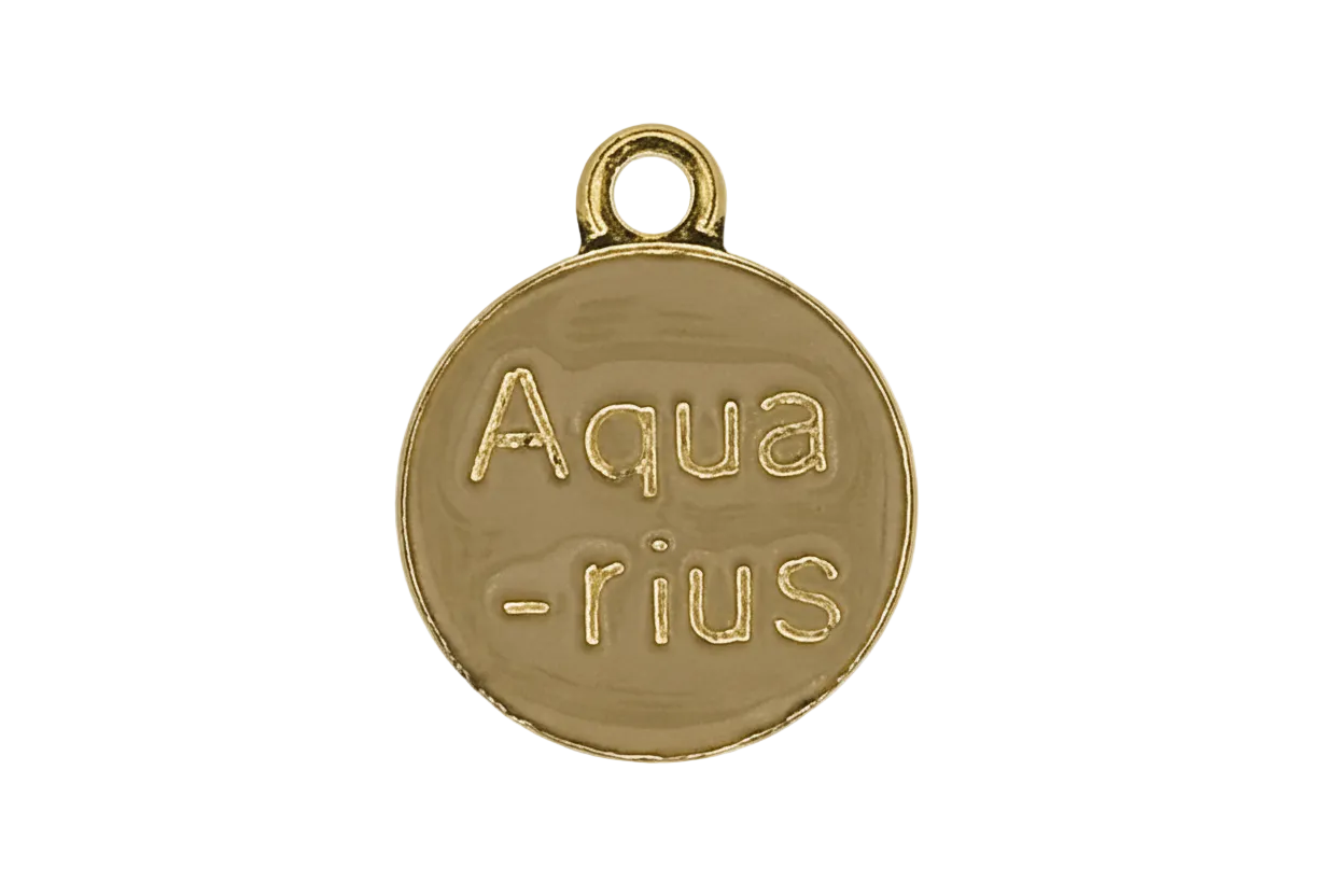 close-up of a small round gold charm engraved with the word Aquarius on a black background