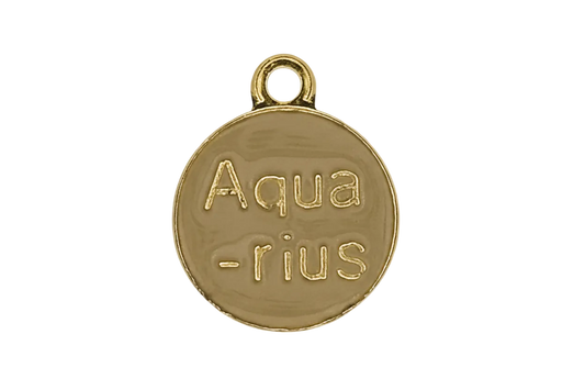 close-up of a small round gold charm engraved with the word Aquarius on a black background