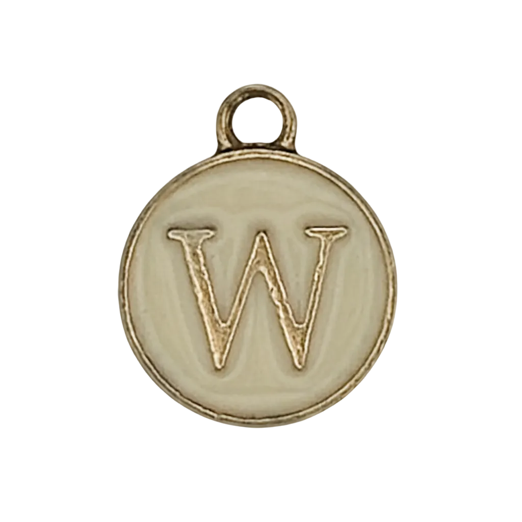 close-up of round ivory and gold charm with letter W