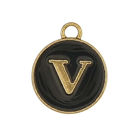 close-up of small round black charm with raised gold letter V