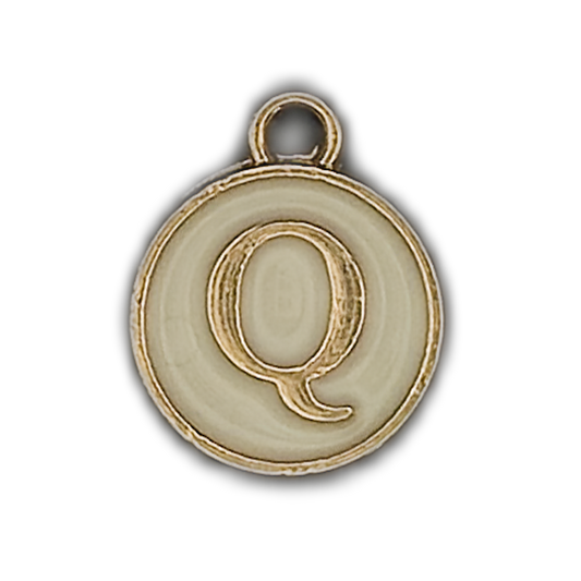 close-up of round gold-trim letter Q charm on cream background