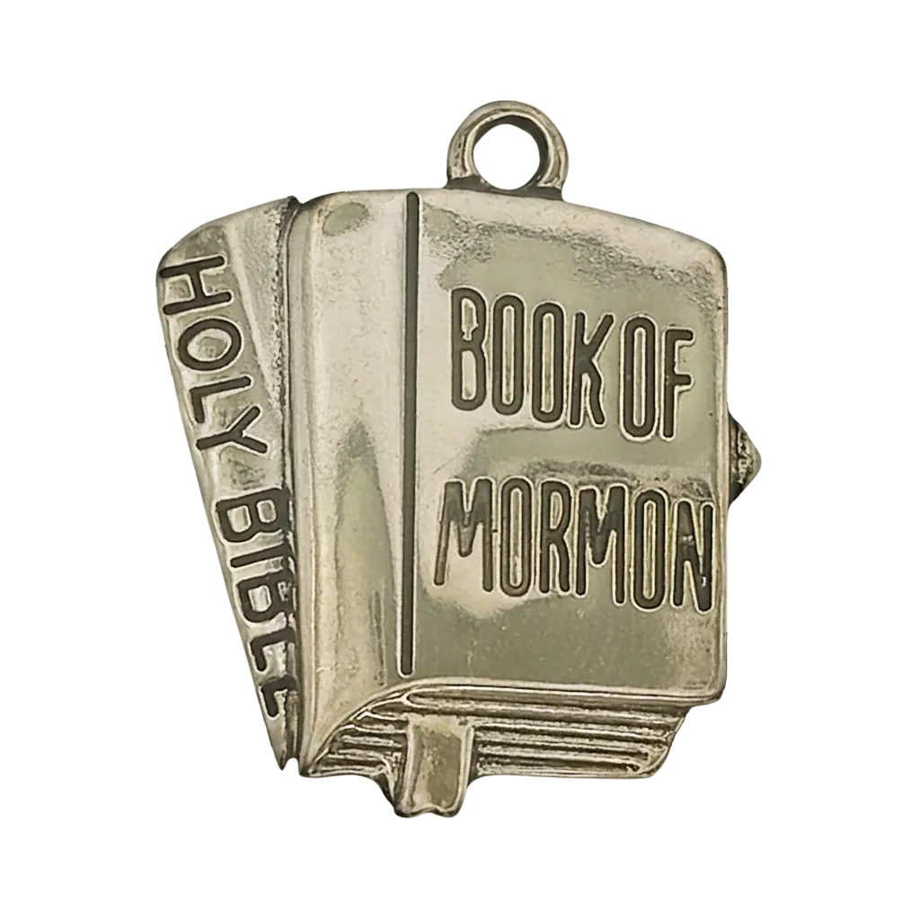 Close-up of gold-tone book charm with "Book of Mormon" on the cover and "Holy Bible" on the spine.