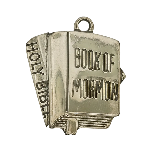Close-up of gold-tone book charm with "Book of Mormon" on the cover and "Holy Bible" on the spine.