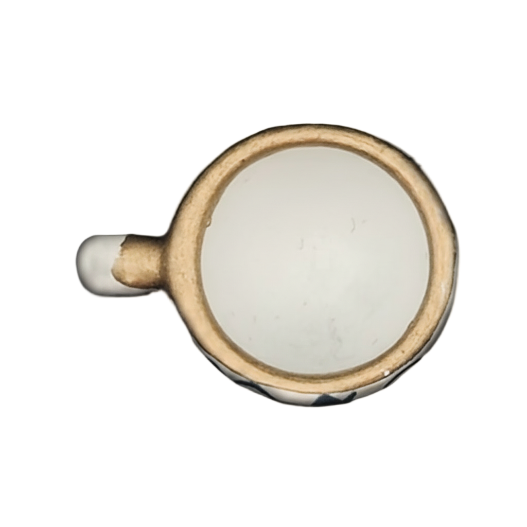 top-down gold-tone rimmed white cup charm on black background