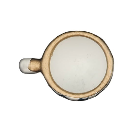 top-down gold-tone rimmed white cup charm on black background