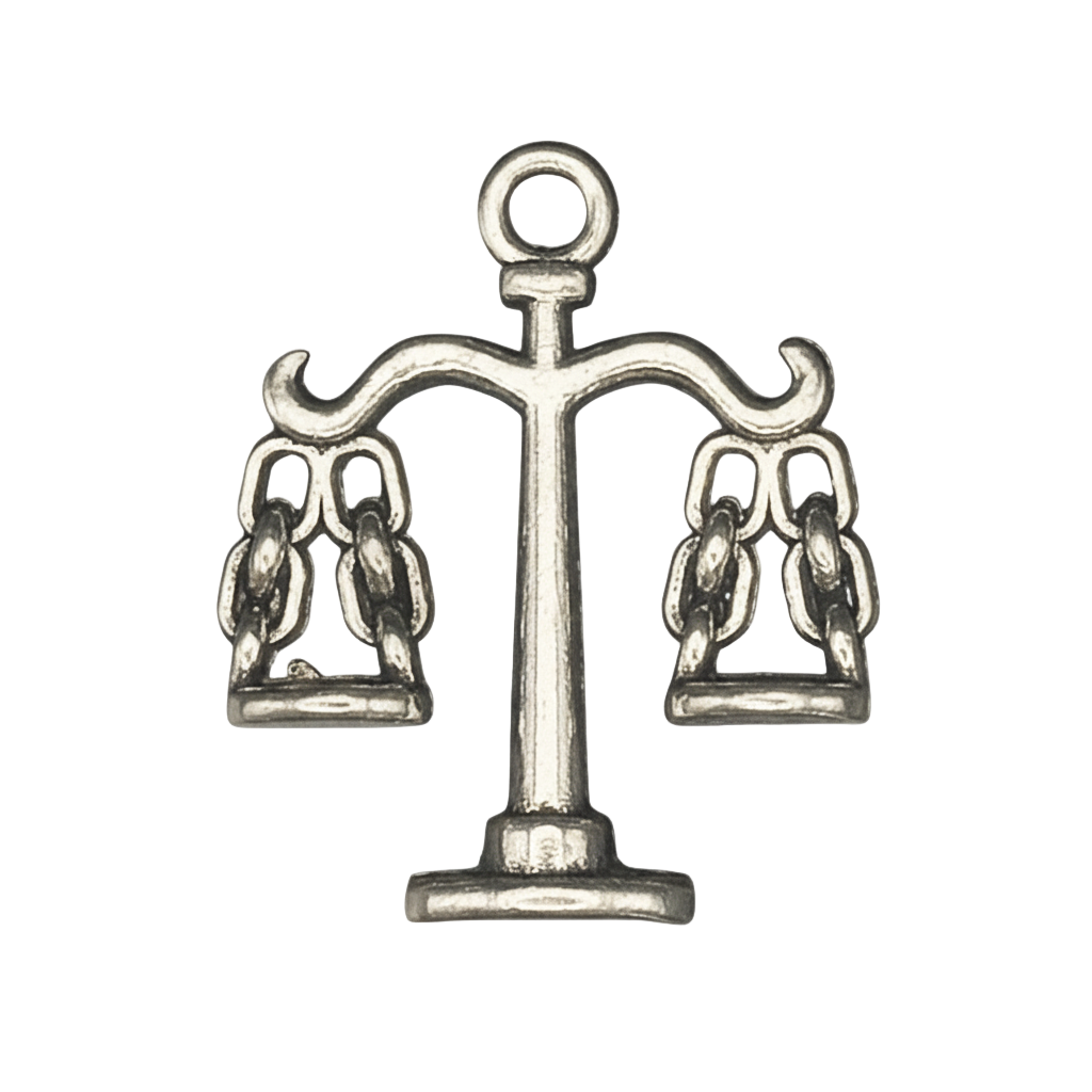 close-up of a silver-tone scales-of-justice charm on black background