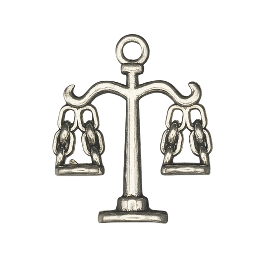 close-up of a silver-tone scales-of-justice charm on black background