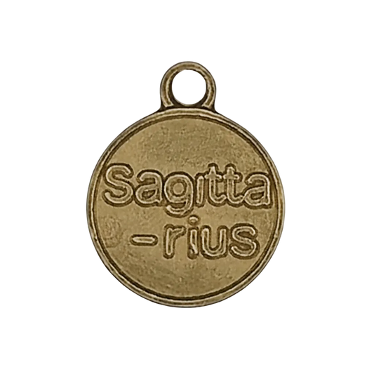 close-up of round gold-tone charm reading 'Sagittarius'