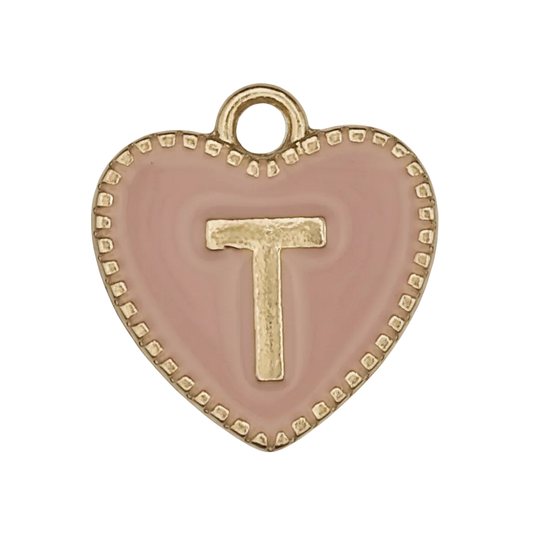 Close-up of pink heart charm with a gold letter T and dotted border.