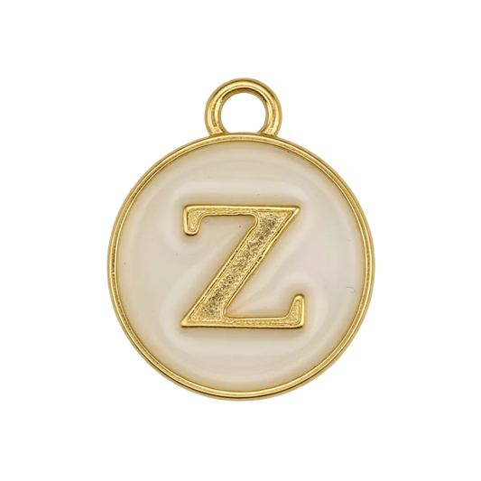 close-up of round cream enamel charm with raised gold letter Z