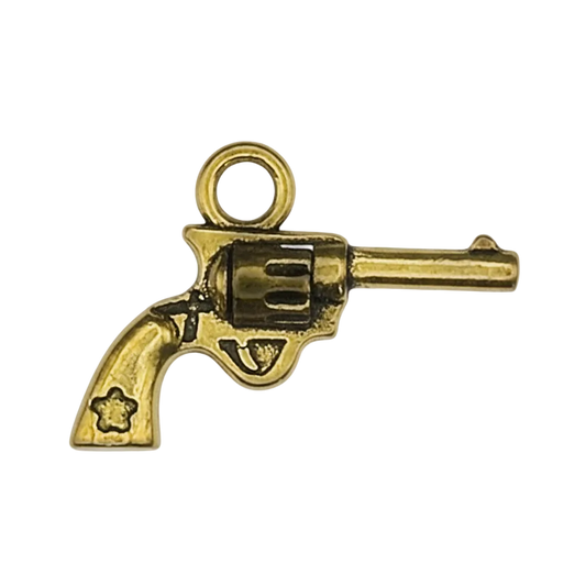close-up of a small gold revolver charm
