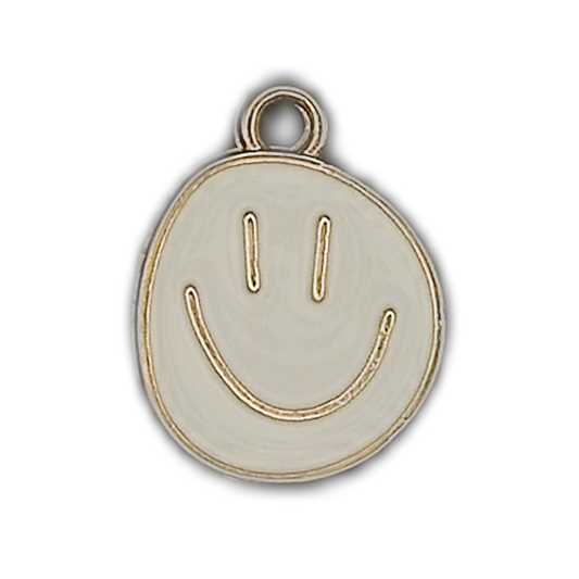 close-up of a white enamel smiley face charm with gold outline on a black background