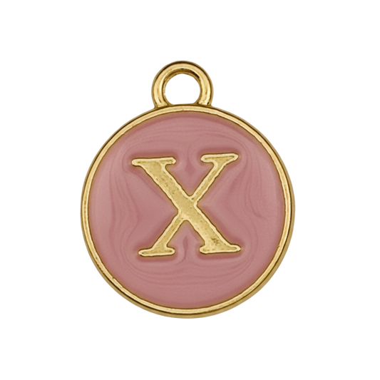Close-up of round pink enamel charm with gold letter X on black background.