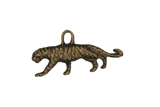 close-up of gold-tone walking tiger charm on black background
