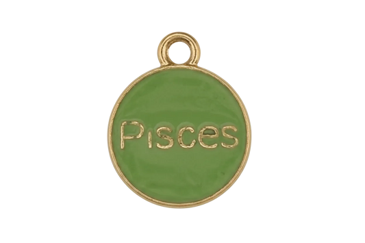 Close-up of a round green enamel charm with gold 'Pisces' text and edge on a black background.