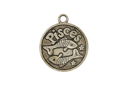 close-up of round bronze pisces charm with two fish and stars