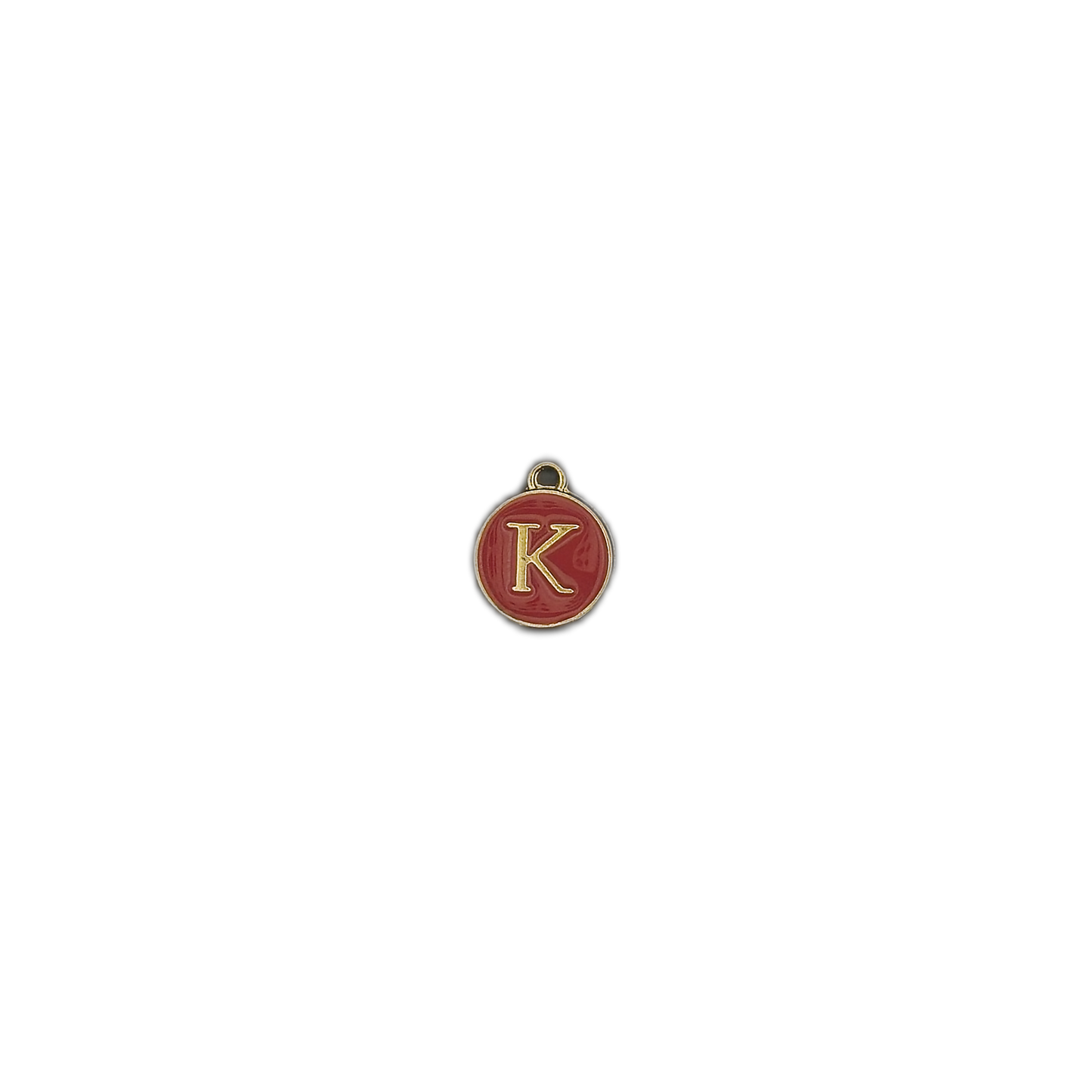 Centered view of a small round red charm with a gold letter K on a black background.