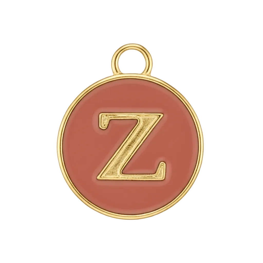 Close-up of round red enamel charm with a gold letter Z.
