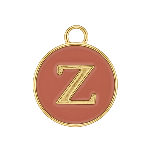 Close-up of round red enamel charm with a gold letter Z.
