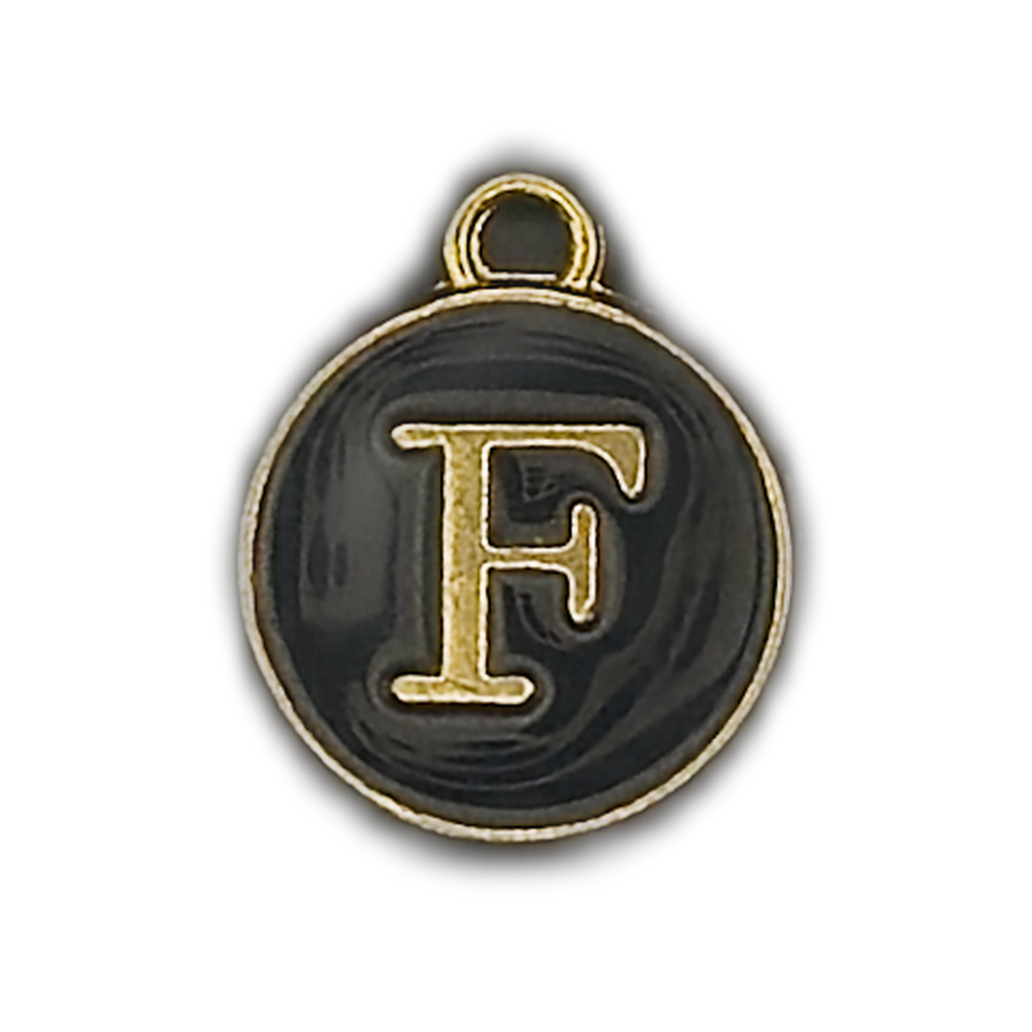 close-up of round black enamel charm with gold letter F