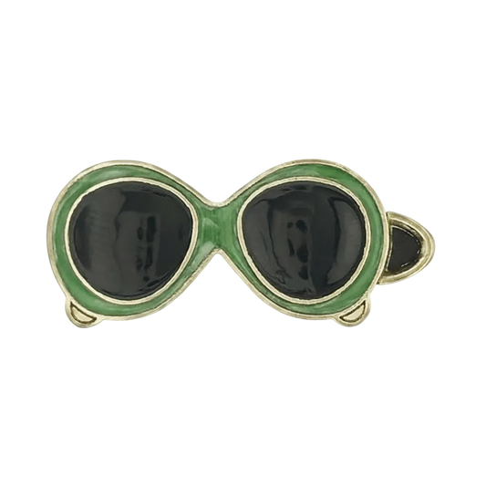 close-up of green-framed black-lens sunglasses charm on a black background
