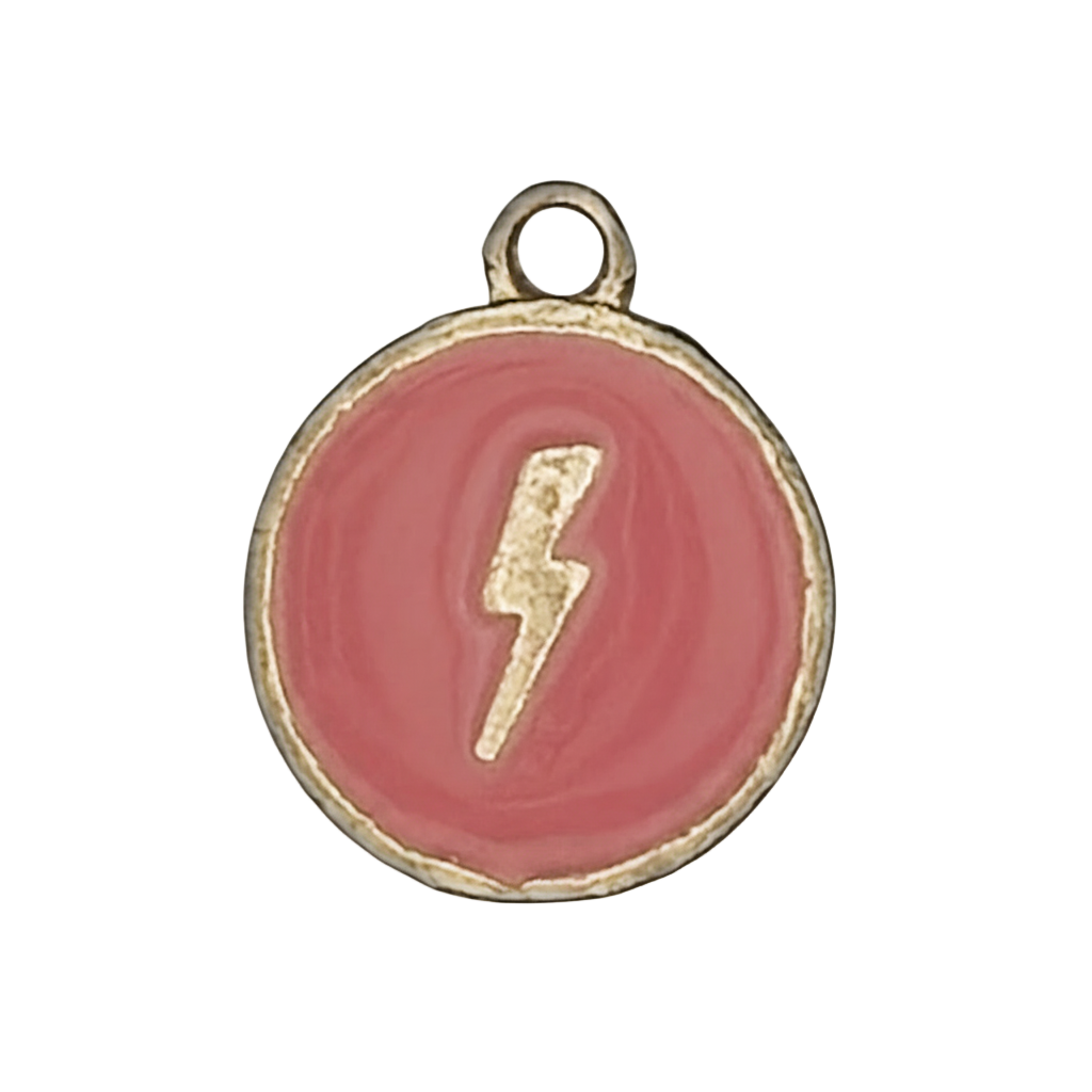 close-up of round pink enamel charm with a gold lightning bolt