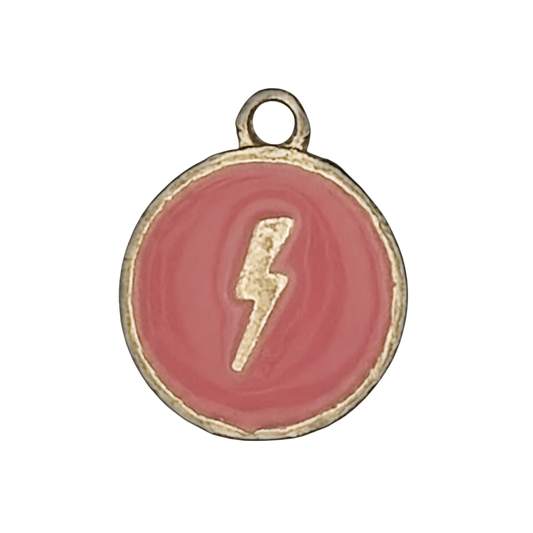 close-up of round pink enamel charm with a gold lightning bolt
