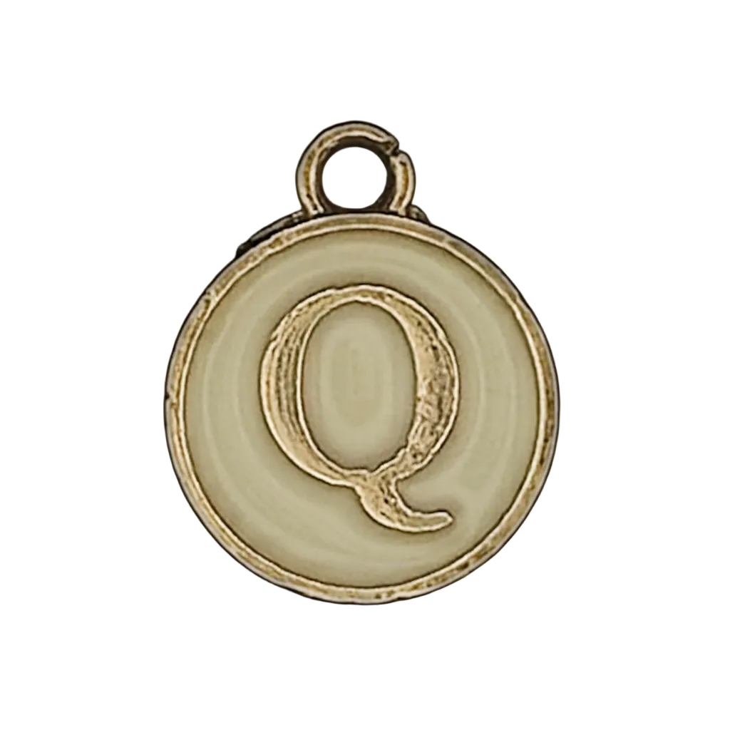 close-up of round cream charm with gold letter Q