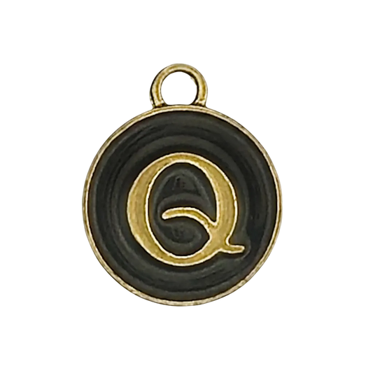 close-up of round black and gold letter Q charm