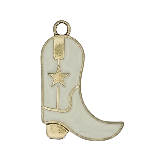 close-up of a white enamel cowboy boot charm with gold star on black background