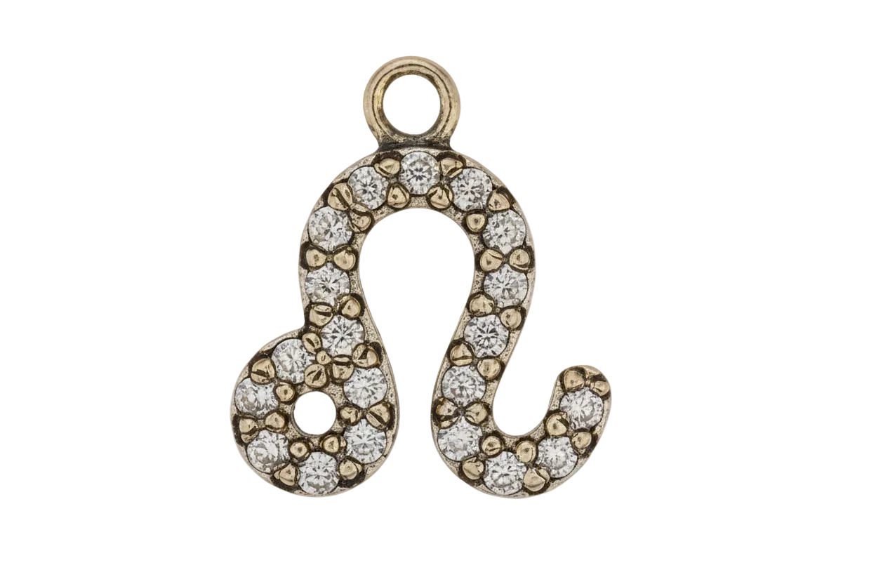 Close-up gold-tone Leo zodiac symbol charm with clear pavé stones on black background.