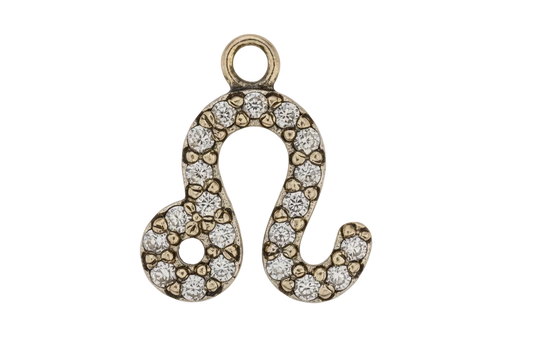 Close-up gold-tone Leo zodiac symbol charm with clear pavé stones on black background.
