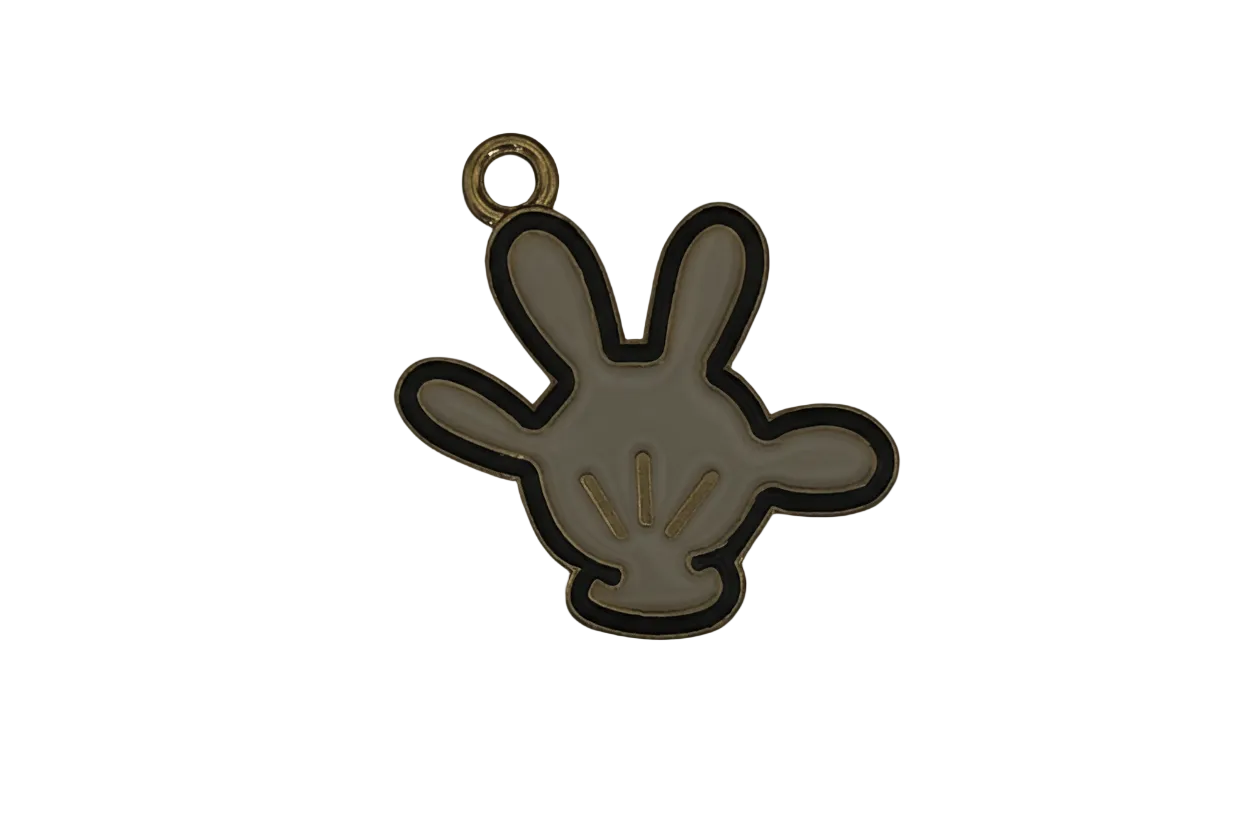 close-up of a small white enamel glove hand charm with gold trim on a black background