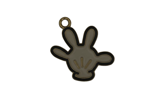 close-up of a small white enamel glove hand charm with gold trim on a black background