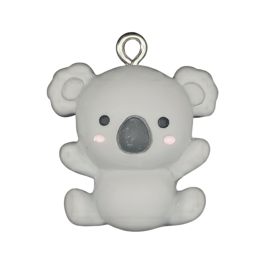 close-up of small gray koala charm with pink cheeks on black background