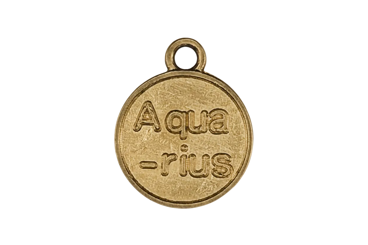 close-up of round gold charm engraved “Aqua-rius” on black background