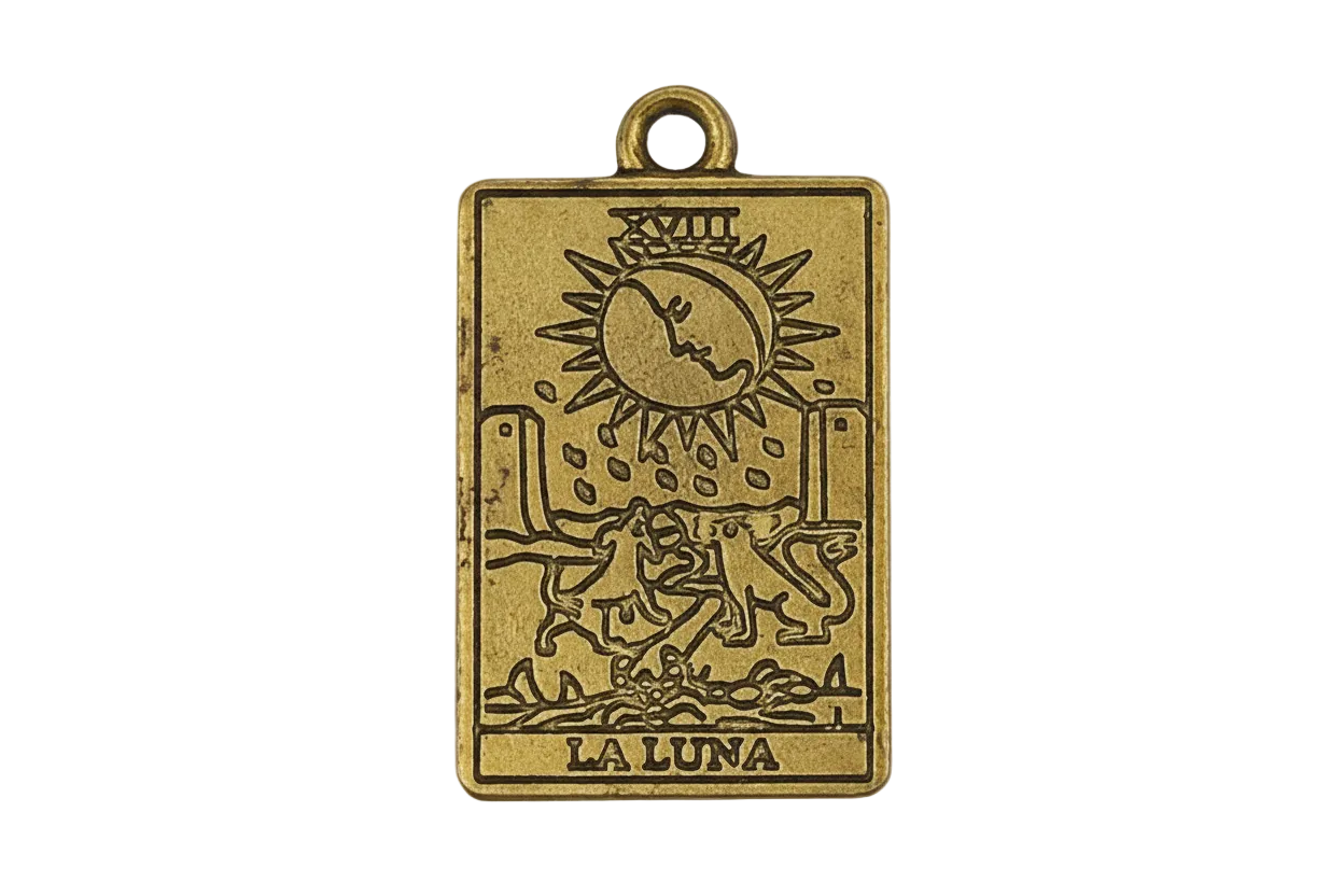 Close-up of rectangular gold-tone La Luna tarot charm with moon and dogs engraving.