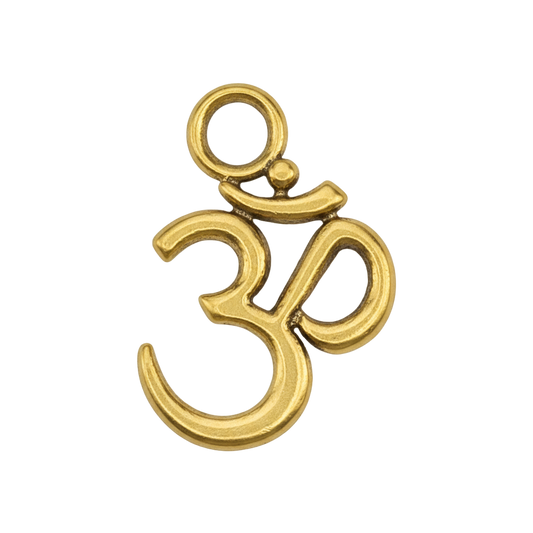 Close-up of a small gold-tone Om symbol charm on a black background.